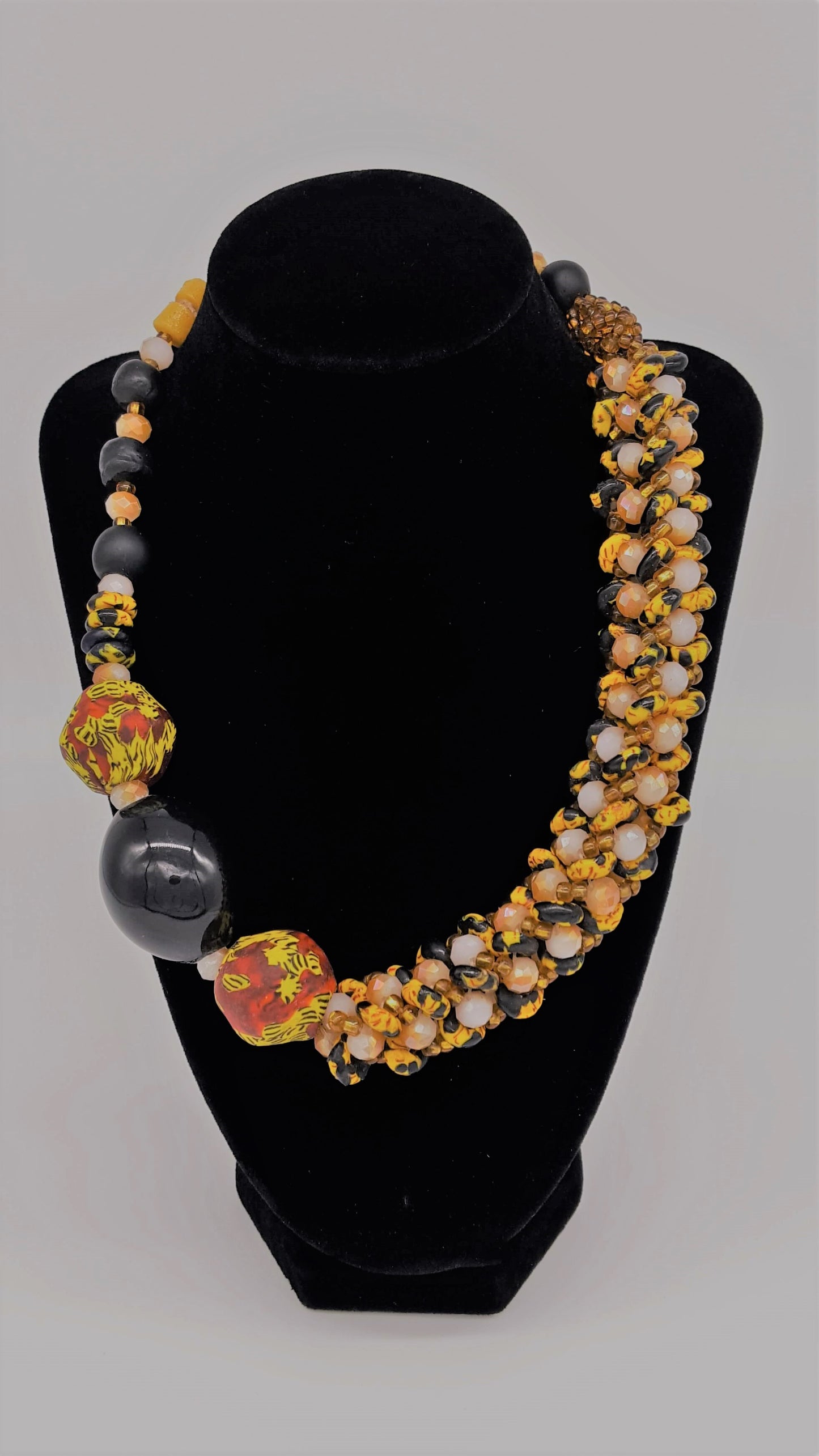 Traditional Ghana yellow glass beaded necklace, with three large colored side beads, front view